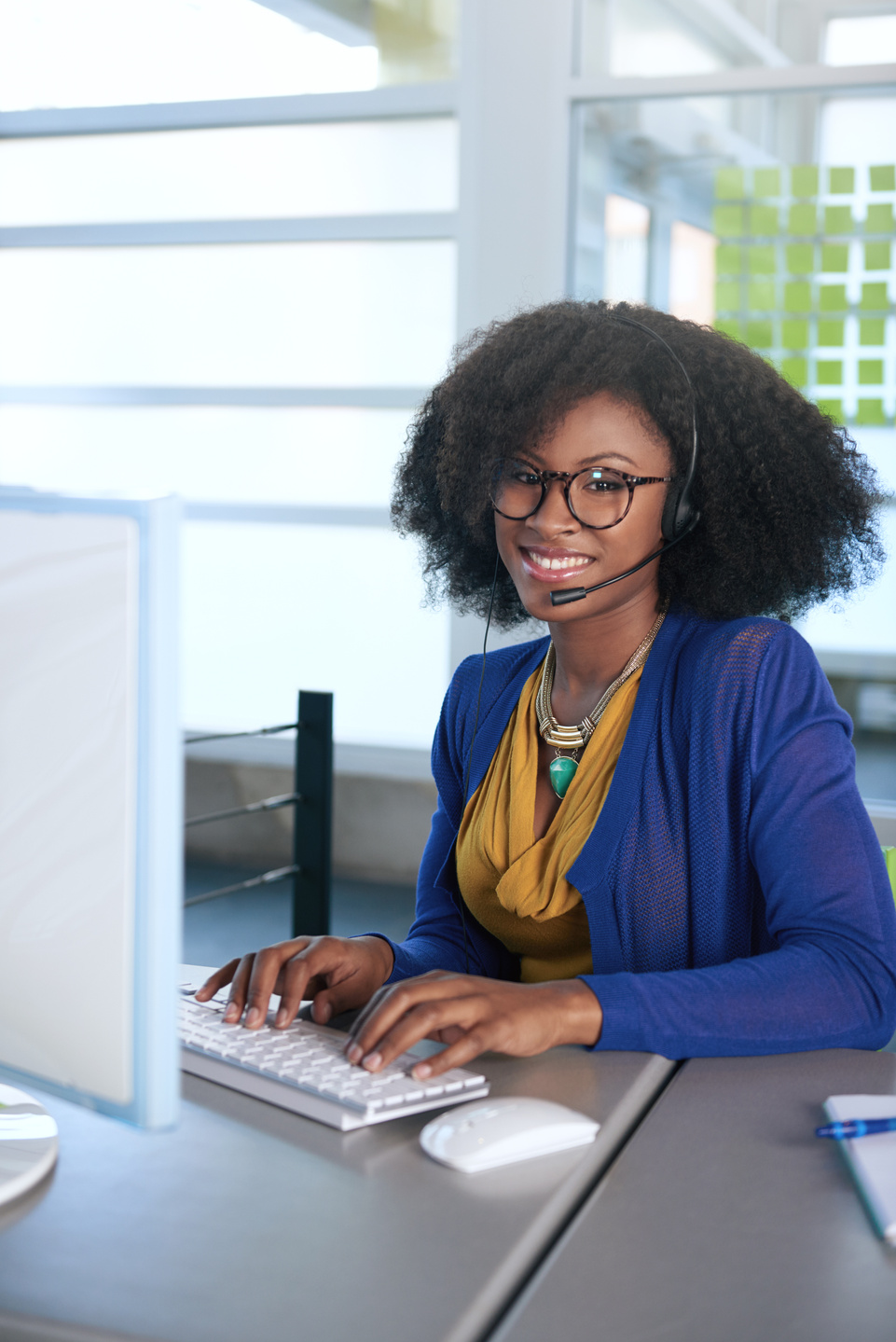 Portrait of a smiling customer service representative with an afro